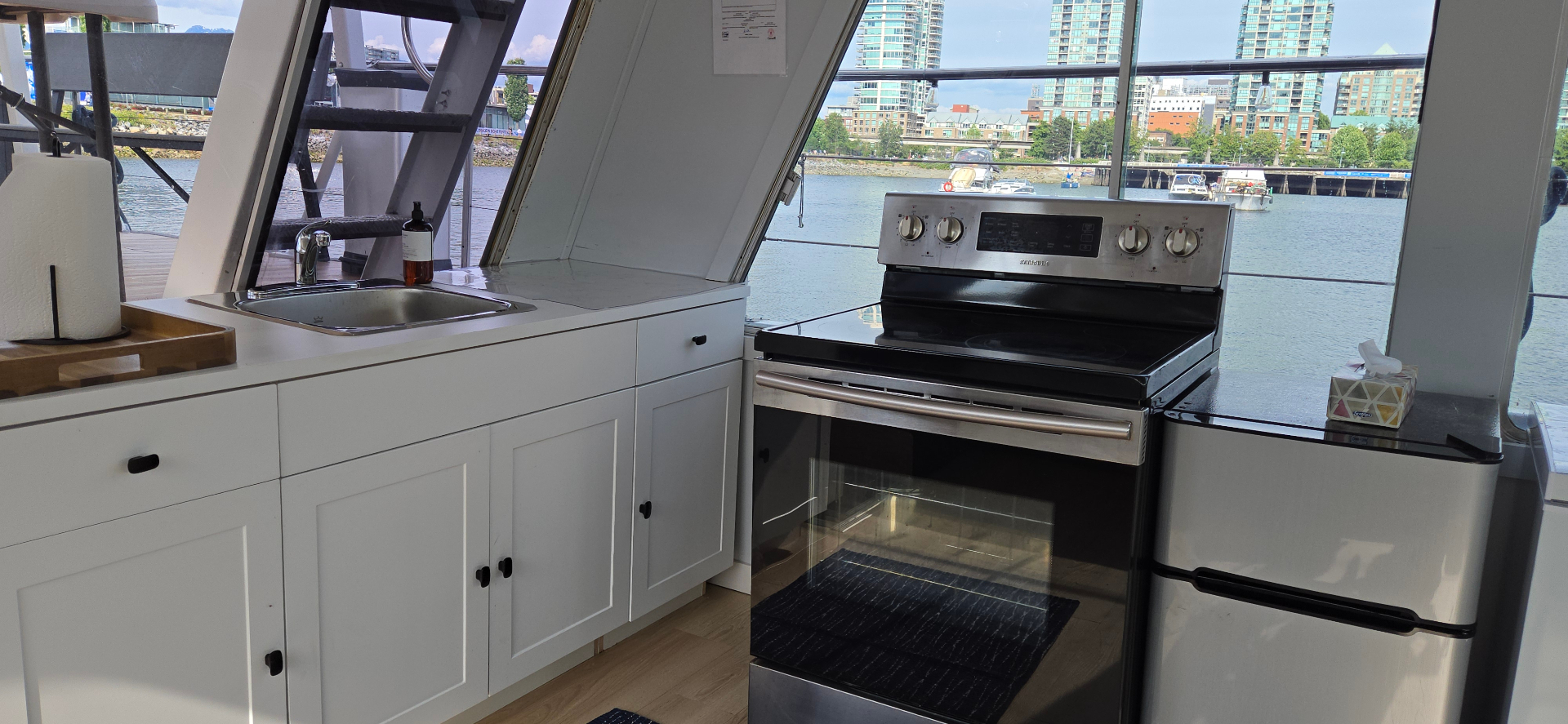 Shangri-La Joy galley kitchen with full stove, sink, and skyline views